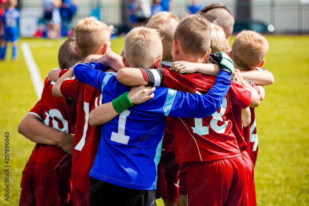 Team Sports for Kids. Children Sports Soccer Team. Coach Motivate Soccer Players to Play as a Team. Boys Kids Soccer Football Game. Young Children In Huddle Building Team Spirit.