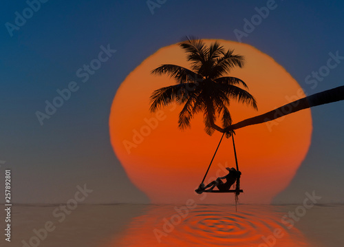 Fairy tale sunset of the large sun drop into the sea with lonely woman sitting on wooden swing under coconut palm tree over the sea beach  enjoy or lonely feel in  long holidays vacation in summer