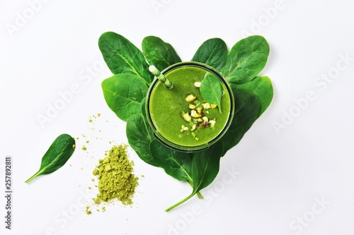 Super green spinach smoothie with matcha green tea isolated on white background. Top view green smoothie