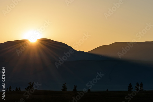 sunrise mountains sun steppe trees
