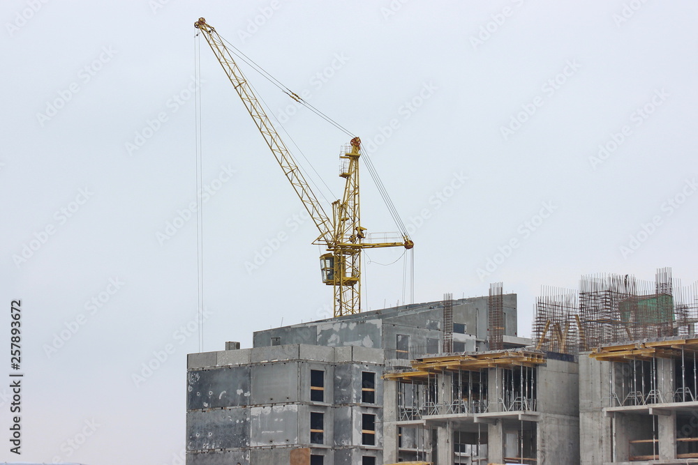 construction works of modern low-rise residential buildings. construction site at the house. cranes, special equipment facilitating work. construction work in progress. reset the frame house.