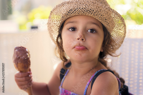 Girl with nose smeared with chocolate ice cream