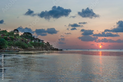 Romantic sunset on a tropical island with white sand beach at a luxury resort