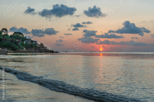 Romantic sunset  on a tropical island with white sand beach at a luxury resort