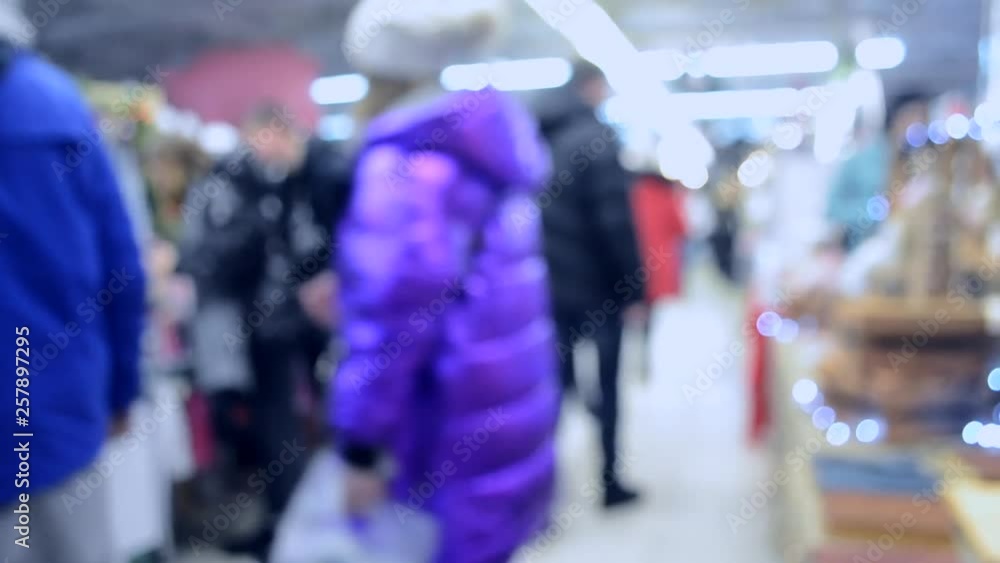 Many people walk inside the mall or store with illumination. Many people walk inside the mall or store with illumination.