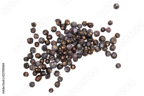 Lot of whole dry juniper berry seed flatlay isolated on white background