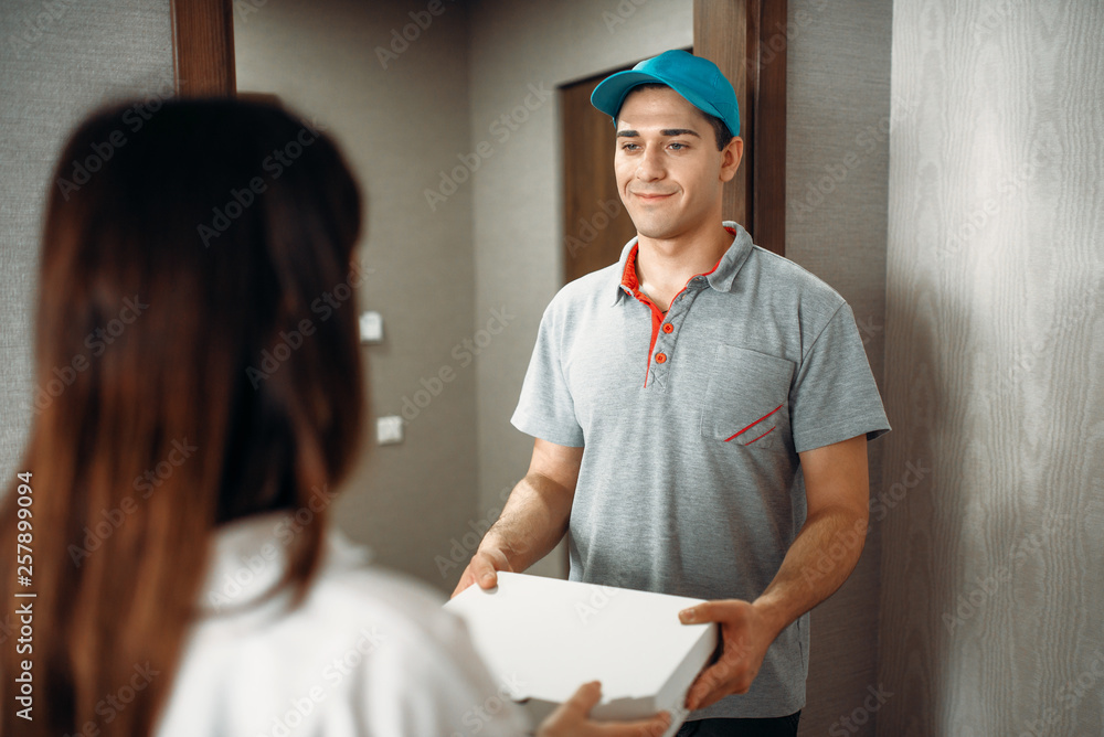 Female customer signs order to pizza delivery boy Female customer signs order to pizza delivery boy