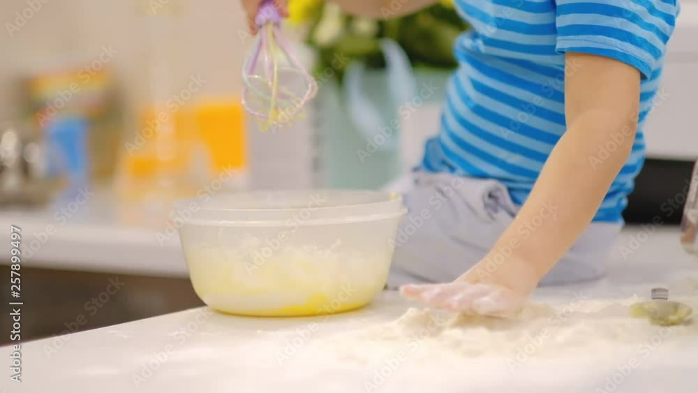 grandmother and grandson have fun together. a happy family. Senior woman and little boy Kneading Dough In Flour On Table grandmother and grandson have fun together. a happy family. Senior woman and little boy Kneading Dough In Flour On Table