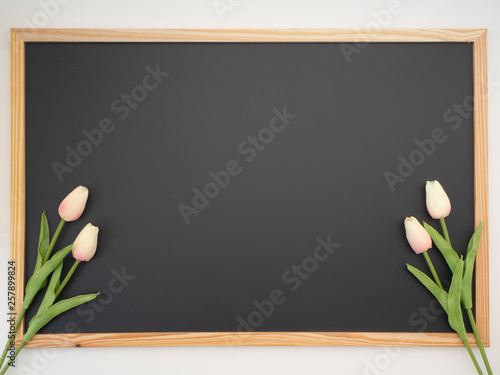 Tulip bouquet placed on the blackboard frame