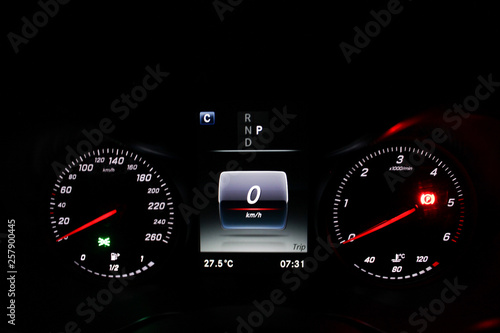 car speedometer dashboard display with the ignition and parking sensor illuminated.