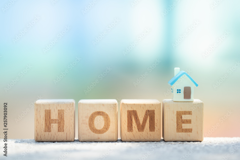 Miniature house model on wooden block text dream. Business, finance, and saving money for dream house concept Miniature house model on wooden block text dream. Business, finance, and saving money for dream house concept