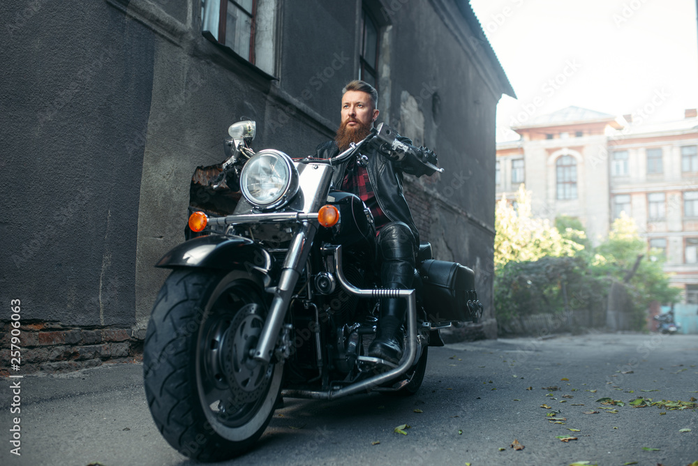 Bearded motorcyclist on classical chopper, biker