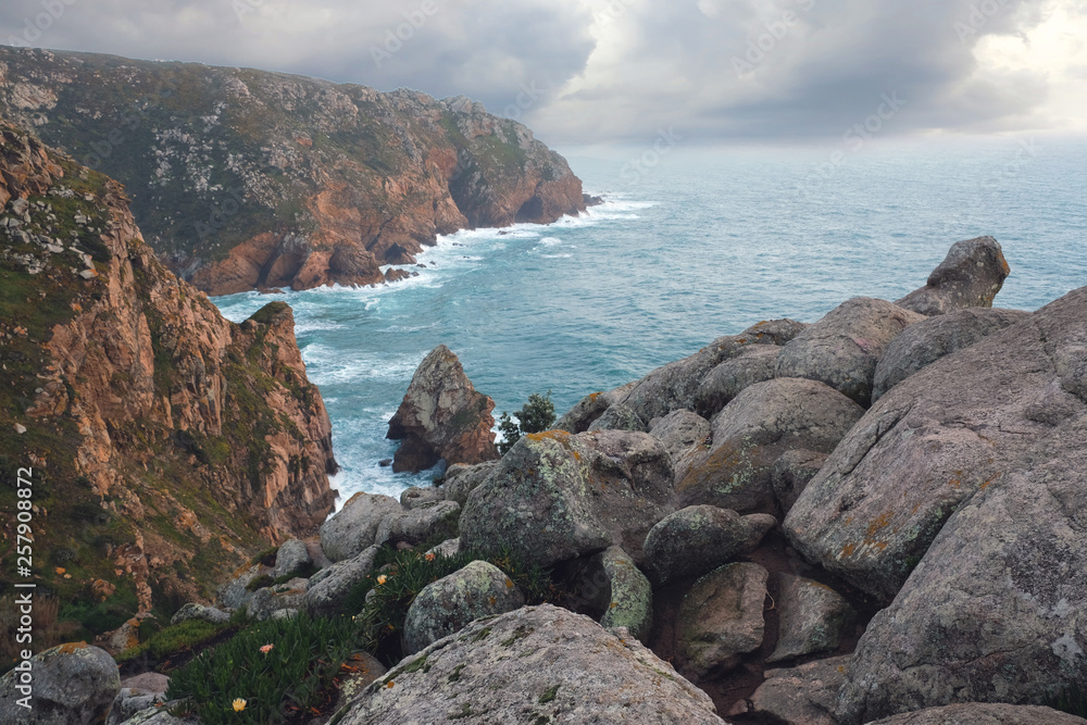 Seascape, rocky coast of the Atlantic Ocean, near Cape Roca in Portugal in the spring cloudy weather