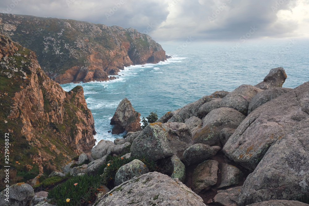 Seascape, rocky coast of the Atlantic Ocean, near Cape Roca in Portugal in the spring cloudy weather Seascape, rocky coast of the Atlantic Ocean, near Cape Roca in Portugal in the spring cloudy weather