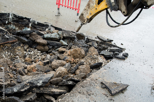 Repair of communications located under the carriageway. Road repair car breaks asphalt.