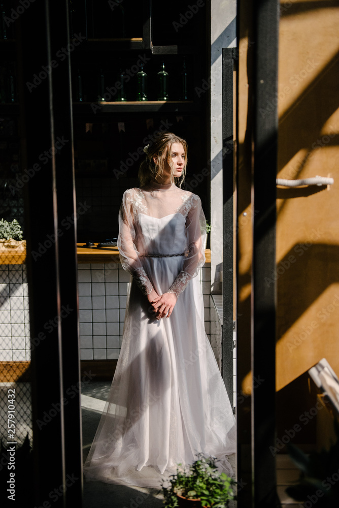 Bride in white wedding dress posing indoors Bride in white wedding dress posing indoors