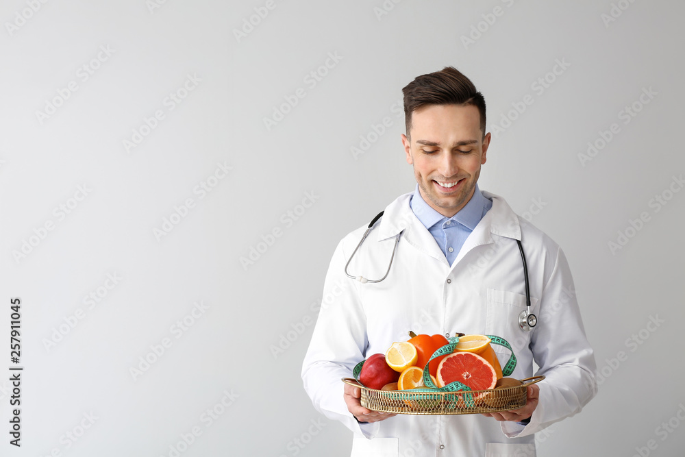 Portrait of male nutritionist on light background Portrait of male nutritionist on light background
