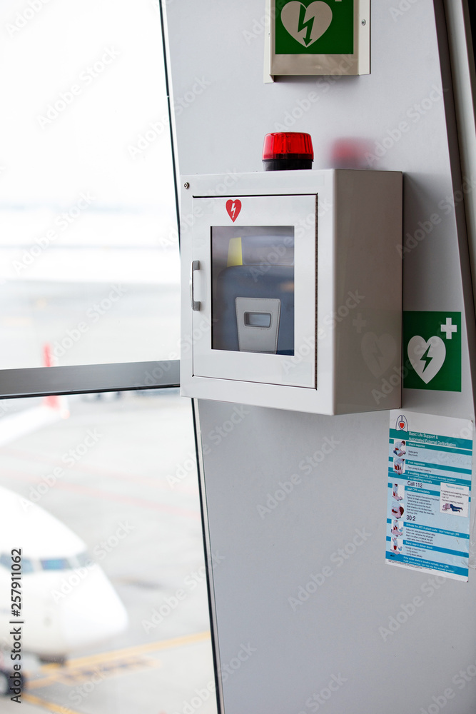defibrillator attached to the wall at the airport Stock Photo Adobe Stock