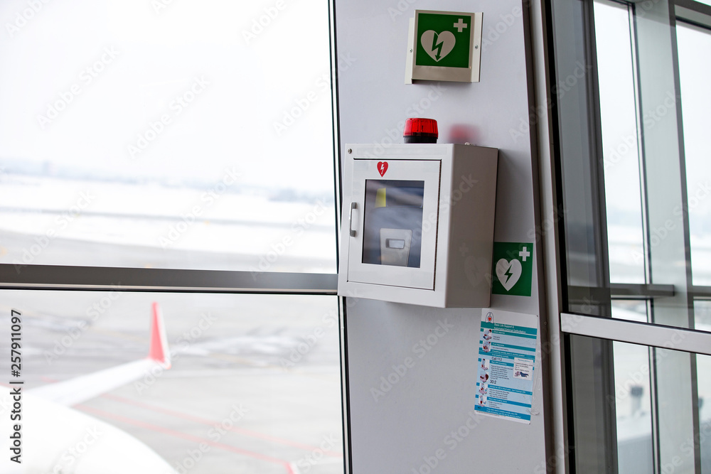 defibrillator attached to the wall at the airport Stock Photo Adobe Stock