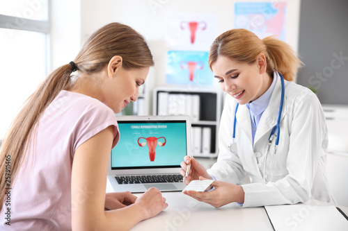 Young woman visiting her gynecologist in clinic photo