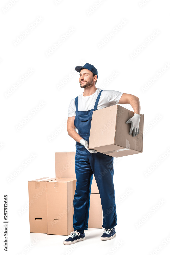 handsome mover in uniform carrying cardboard box isolated on white handsome mover in uniform carrying cardboard box isolated on white
