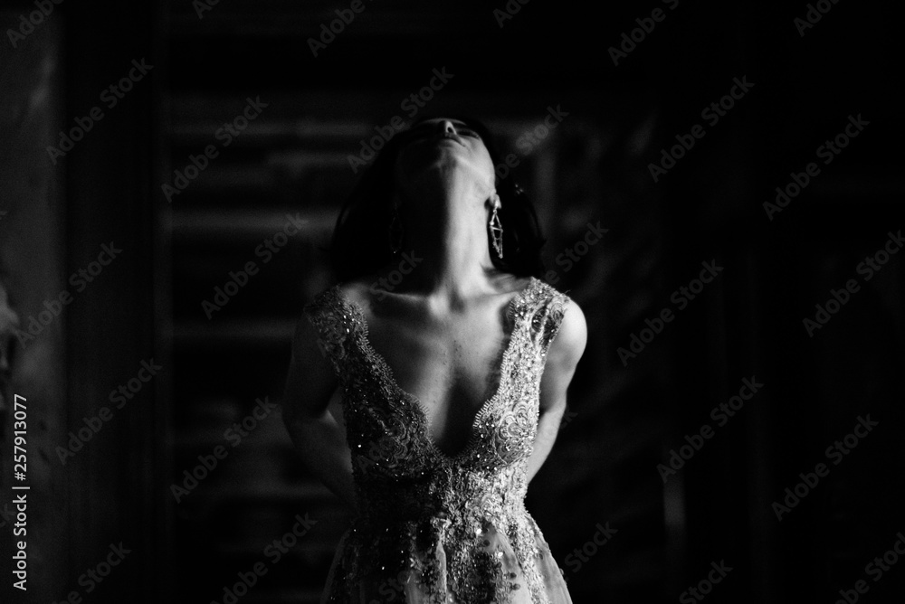 Model posing in a white long wedding dress indoors by the window. Advertising of wedding dresses Model posing in a white long wedding dress indoors by the window. Advertising of wedding dresses