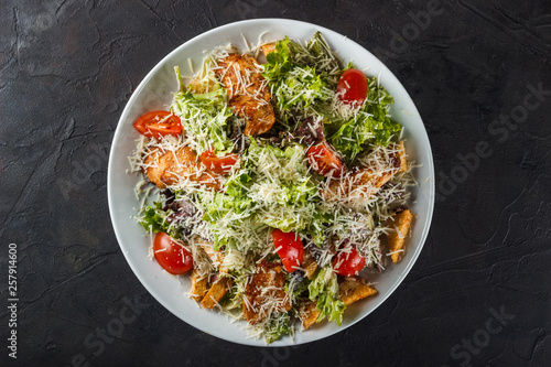 Caesar salad with chicken fillet, cherry tomatoes and parmesan cheese