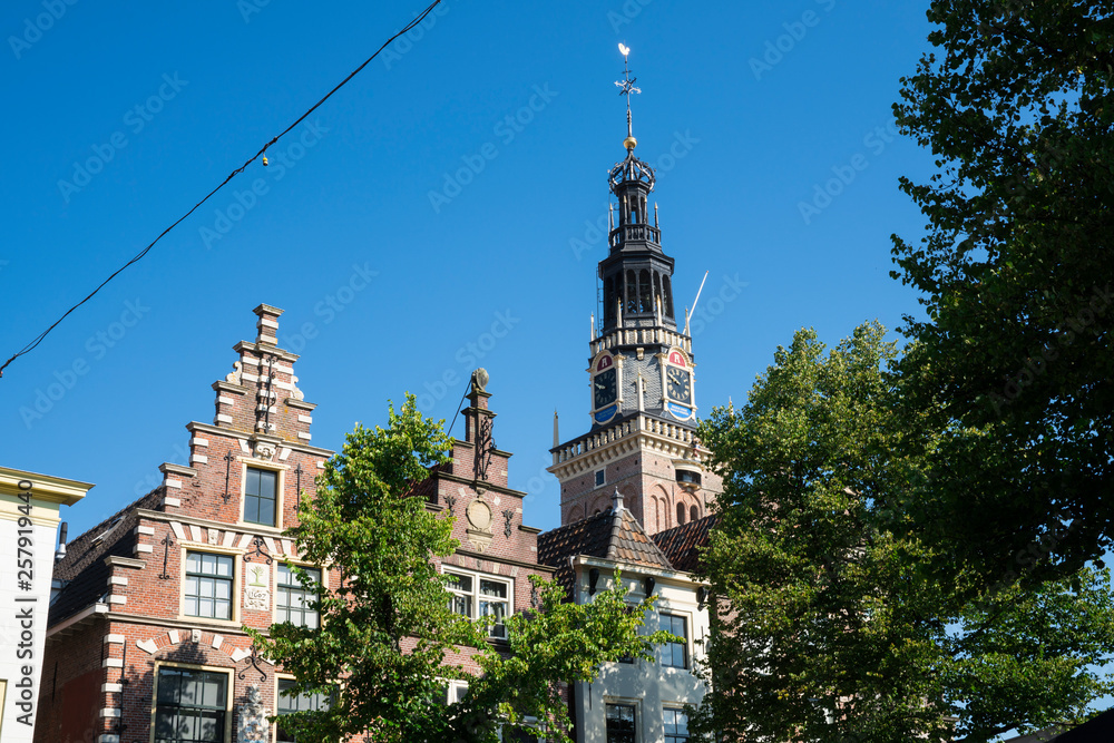 Obraz premium Tower of Waag and stepped gable houses, Alkmaar, The Netherlands. Against blue sky