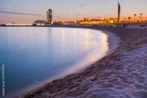 Photography peaceful and relaxing view of barcelona beach during purple warm summer sunset w