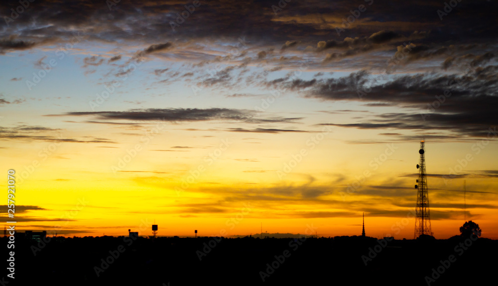 Sunset and golden light with Silhouette city. High level of noise. Night sky with cloud.