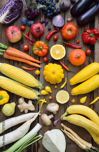 Fototapeta Naklejka Na Ścianę i Meble -  Yellow, orange, red, purple fruits and vegetables on wooden background.  Healthy food. Multicolored raw food. Copy space
