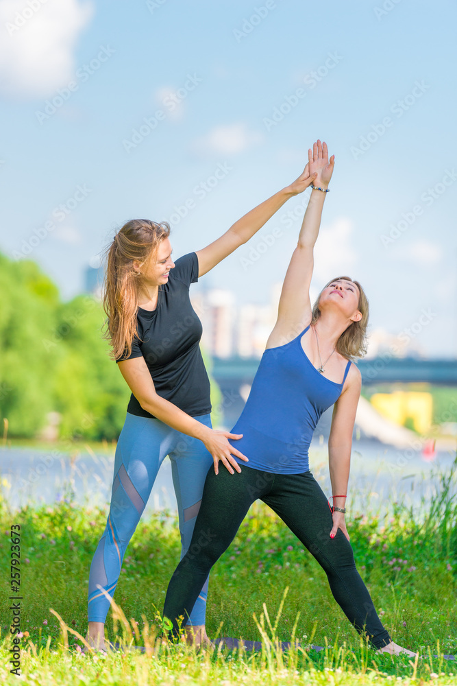 Individual yoga classes with a young experienced trainer in the park Individual yoga classes with a young experienced trainer in the park