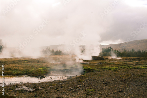 stunning Iceland geyser steam and mountains in plains