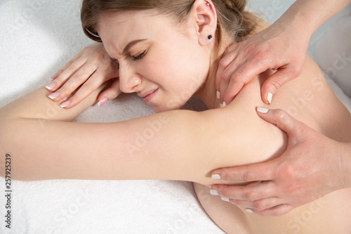 Young woman relaxing with hand massage at beauty spa.