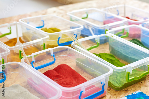Multi-colored sand for drawing in plastic containers
