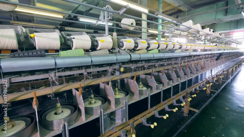 Premises of textile factory with spools getting unwound Premises of textile factory with spools getting unwound
