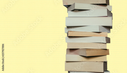 Literature for study: Stack of books; yellowbackground