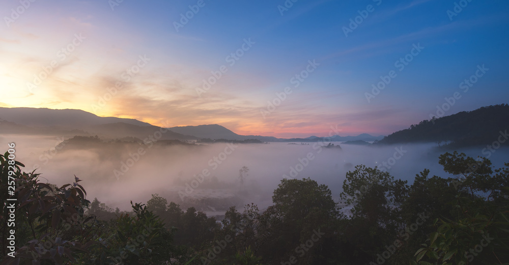 Fototapeta premium Aerial view of tropical rain forest in the mist, Landscape morning fog on Baan Hatsompaen Viewpoint Ranong Tropical rain forest at southern of Thailand