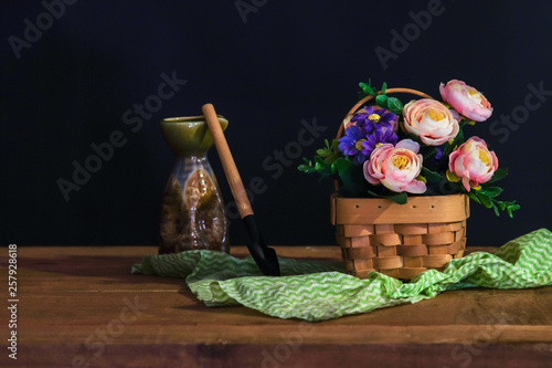 Still life with pink roses in basket on the table .