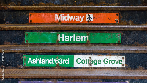 A metal stairs with various signs of Chicago city
