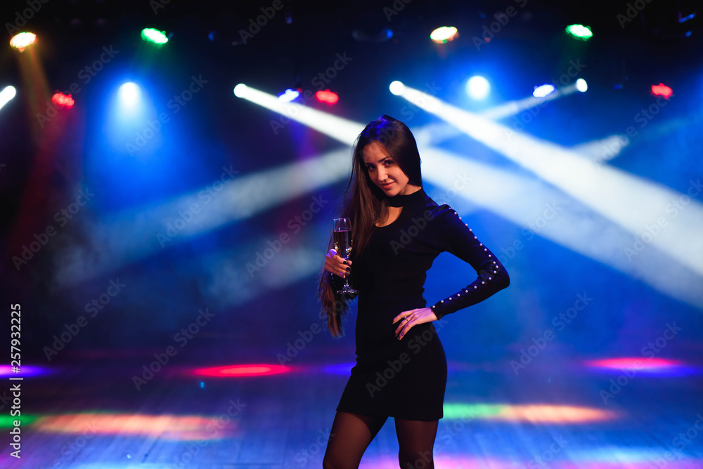 young woman in front of a club background