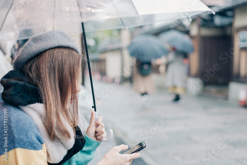 Lonely woman  with umbrella is waiting for the rain on the street  in Japan.