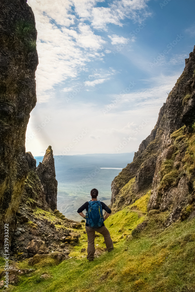 Standing young woman, admiring the view over Isle of Skye, The Quiraing, Scotland, UK