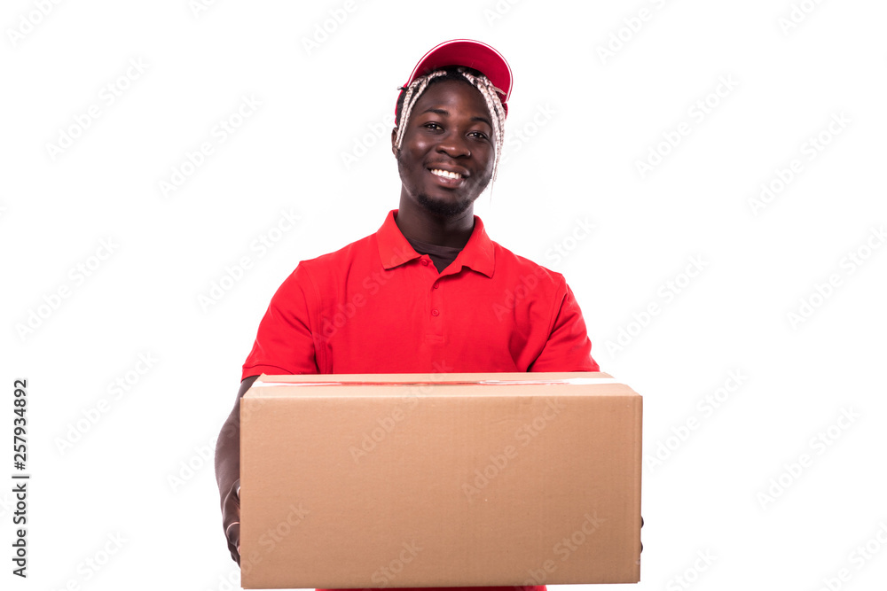 Portrait of African American delivery man in red cloth holding a box package on white background Portrait of African American delivery man in red cloth holding a box package on white background