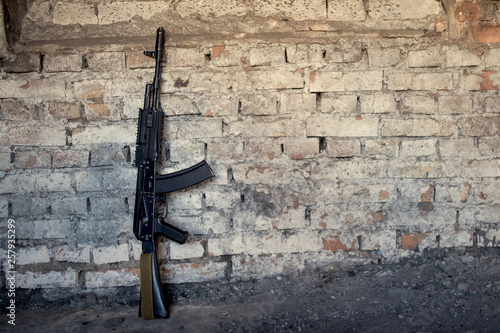 old submachine gun kalashnikov AK-47 against the wall photo