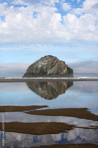 Cannon Rock On the Oregon Coast Reflected at Low Tide on a Beautiful Cloudy Morning