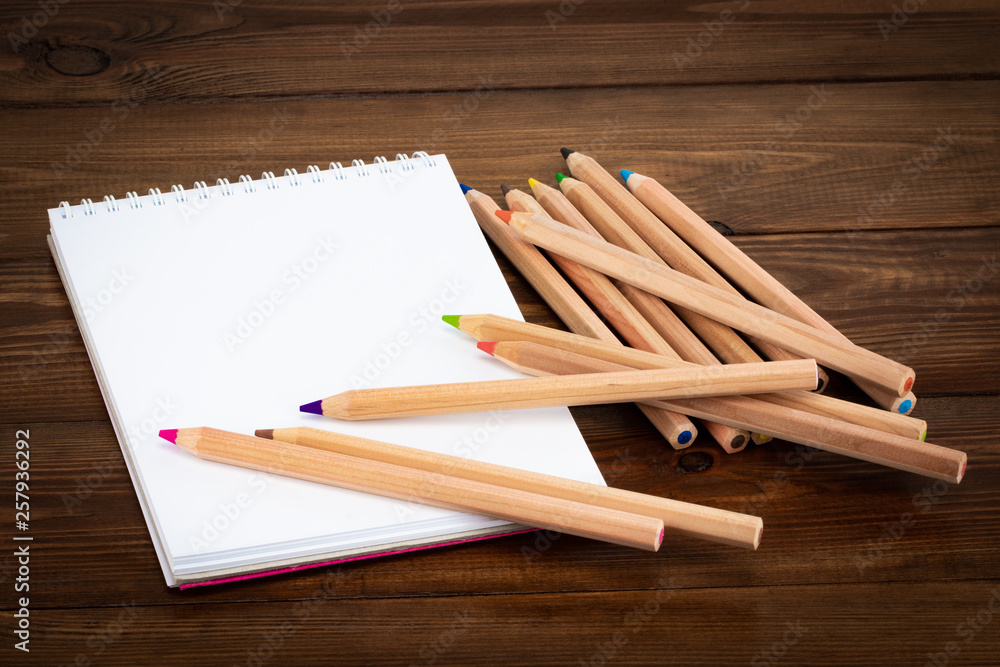 Blank notepad and pencil color on wooden blackground Blank notepad and pencil color on wooden blackground