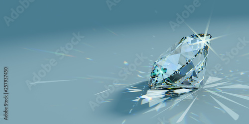 Close-up round cut diamond with caustics rays on turquoise background, side view