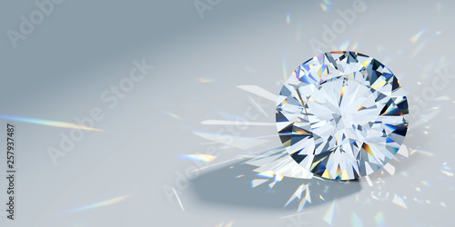 Close-up round cut diamond with caustics rays on light blue background