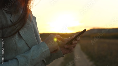 girl's fingers touch screen of the smartphone. close-up. Women's hands hold the smartphone and browser website and email. girl's hand is typing mobile message on smartphone screen.